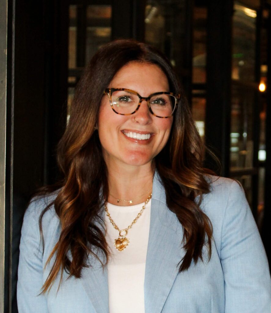 An image of licensed account manager Sarah Smoker wearing a light blue blazer and smiling