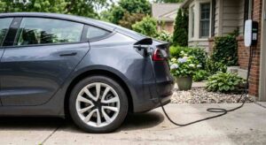 Driver charging an electric vehicle at home with EV insurance Colorado coverage